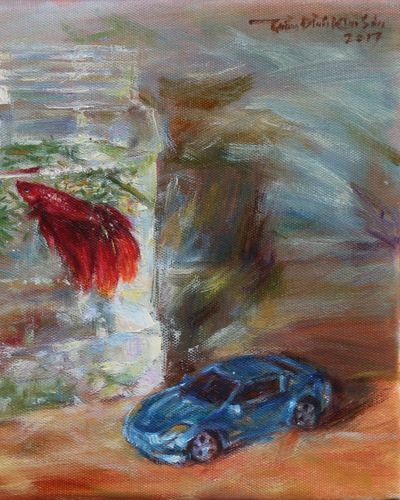 Red betta fish and toy cars. Feb. 2017.